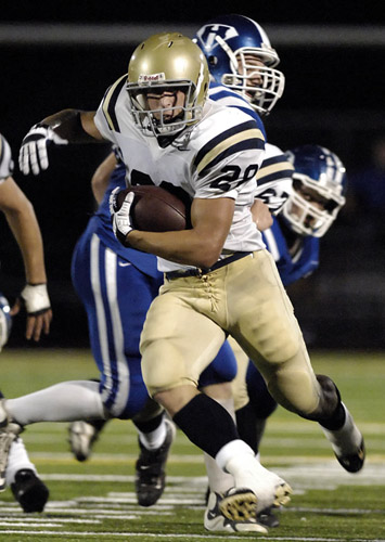 HHS_WAHS_DSC3938b Anthony LaCoste of West Albany flies by the Hillsboro defensive line on his way to a 22 yard gain in the first quarter for first and goal-to-go at the Hillsboro seven yard line.