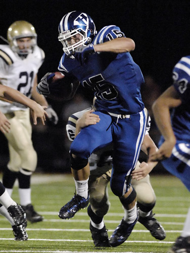 HHS_WAHS_DSC4466b Colt Lyerla of Hillsboro slips past the tackle attempt of West Albany's Tyler Headrick as he rushes for a six yard gain early in the fourth quarter.