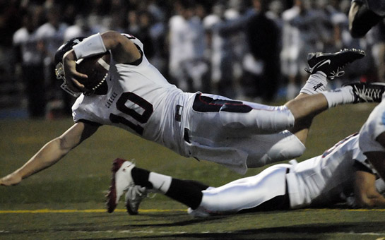 LHS_LOHS_DSC0716b Will Storey of Lake Oswego dives into the endzone to score the Lakers’ first touchdown on their opening drive with 11:15 left to play in the first quarter.
