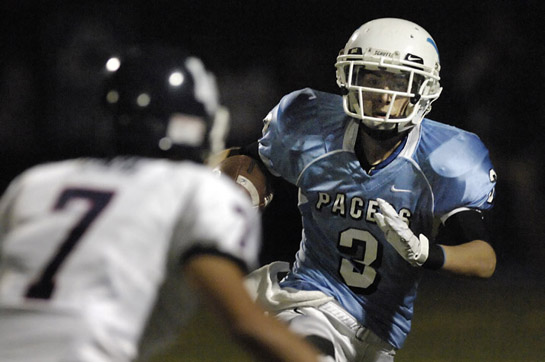 LHS_LOHS_DSC2307b Chase Wippert (3) of Lakeridge attempts to elude the tackle of Lake Oswego’s Danny Oyama during a kickoff return ing the second quarter.
