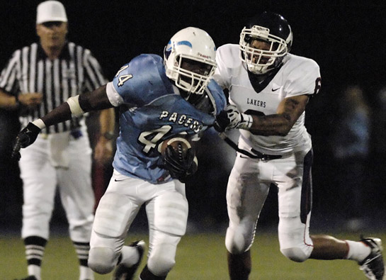 LHS_LOHS_DSC2366b Myke Tavarres (44) of Lakeridge rushes around the right end as he looks to avoid the defense of Lake Oswego’s Tyson Coleman (6) as he rushes for short yardage during the second quarter.