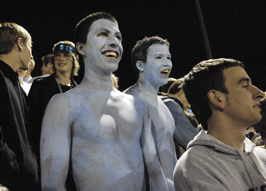 LHS_LOHS_DSC2654b Lakeridge seniors Amador Marcano (left) and Cody Palmer (right) show their spirit as they brave the chilly Fall evening air as they wear only Lakeridge Columbia blue body paint to cover their upper body.