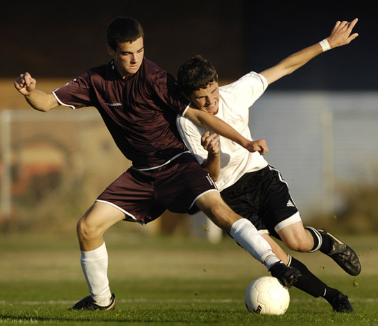 SHHS_GHS_DSC6139b Defender Zach Furrow shields off the pressure of a St. Helens forward during first half play of Glencoe's 2-0 win over the Lions.