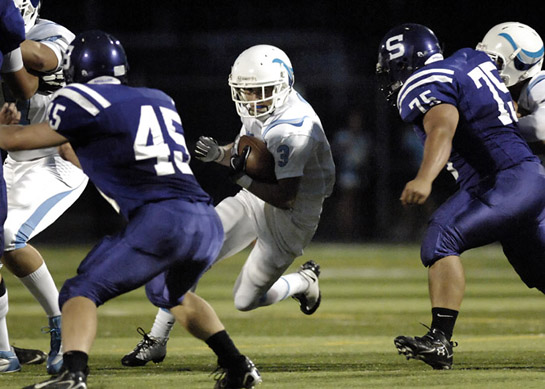 SHS_LHS_DSC8628b Lakeridge quarterback Ben Swinford (9) cuts towards an opening in the line, but his run is held for a short gain as Sunset's Michael Metter (75) steps in for the tackle.
