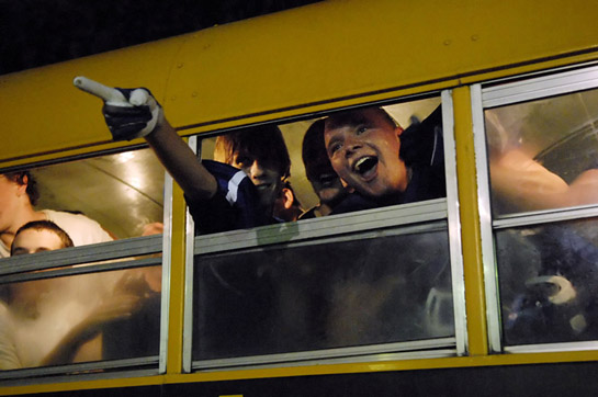 SPHS_PHS_DSC1846b Being all smiles after they celebrate their 34-24 victory over Perrydale, Matt Brown (Left) and David Ferguson of St. Paul shout out to fellow students as the bus leaves the St. Paul Rodeo Arena to head back to the high school.