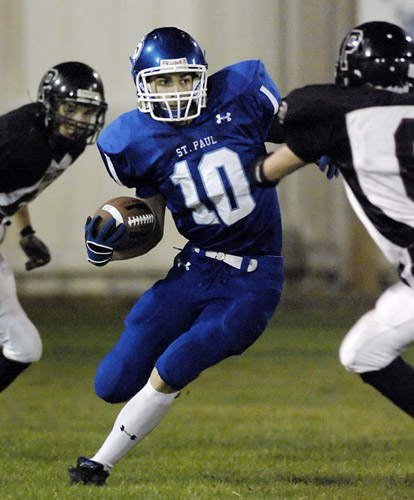 SPHS_PHS_DSC8704b Ryan Pierson of St. Paul runs for an eight yard gain during the opening drive against Perrydale. Pierson rushed for over 300 yards and scored four touchdowns during the Buckaroos’ 34-24 home victory.