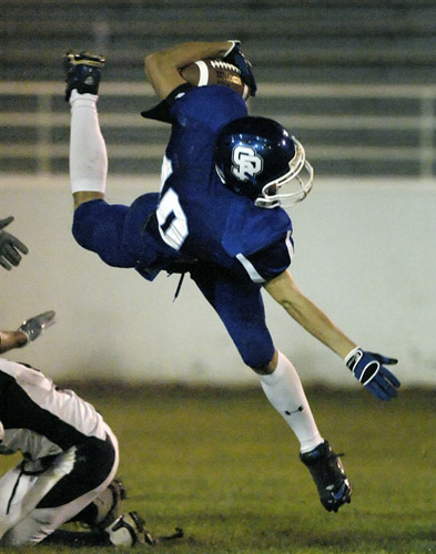 SPHS_PHS_DSC8741b Pierson of St. Paul flies for a few extra yards after being up-ended on a first quarter run.
