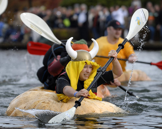 GPR09_DSC2093b A contestant in the growers' race paddles her giant pumpkin in the spirit of the Vikings who are rumored to have crossed the Atlantic in the very same manner in the 18th century.