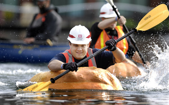 GPR09_DSC7699b Matt Hess of the U.S. Army Corps of Engineers paddles his way across the Lake at the Commons in Tualatin, Oregon as he and other corps members particpate in a challenge race against city of Tualatin employees.