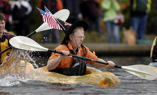GPR09_DSC7899b Costumes of all types added a festive atmosphere to the races. Here a participant in the third race of the day shows his patriatism as he paddles away.