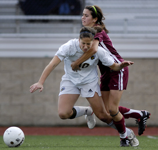 BHS_SHS_DSC6369b Amelia Salazar (behind) of Sherwood resorts to fouling Bend's Daniela Solis (foreground) to prevent her from breaking into the attacking third.