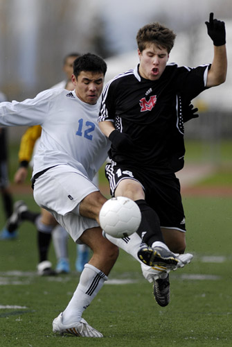 CHS_MVHS_DSC5408b Austin Kins (right) of Mt. View beats Corvallis' Jesus Vidrio (left) to the ball during a first half midfield battle, but pays the price as Vidrio's challenge is late as he connects with Kihs' legs.