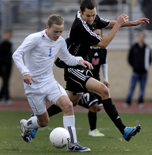 CHS_MVHS_DSC5487b Brian Cronk (left) of Corvallis shields off the defense of Mt. View's Mike Wood (right) at he advances the ball through midfield.