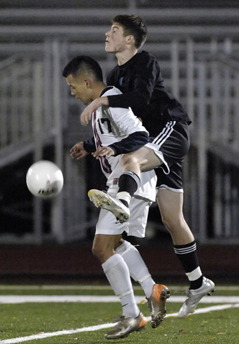 GHS_CHS_DSC3172b Brandon McPheeters (right) of Corvallis rides over the back of Glencoe's David Cazares (left) in an attempt to win possesion. Cazares was able to bring the ball to his feet and evade the pressure of McPheeters.