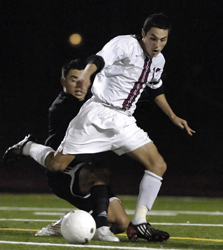 GHS_CHS_DSC3205b Luis Echeverria (right) of Glencoe avoids a tackle in midfield by Corvallis' Jesus Vidrio (left).