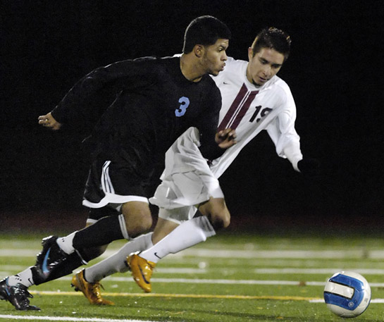 GHS_CHS_DSC4053b Andres Nieves-Bernal (left) of Corvallis looks for a pass upfield under pressure from Alan Portilla (right) of Glencoe.