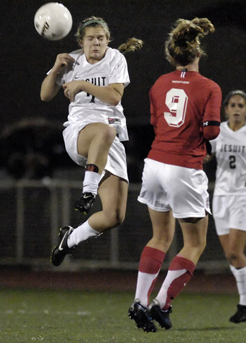 JSH_WHS_DSC8587b Rebe Wolverton (left) of Jesuit heads the ball past Westview's Amanda Minter during second half play.