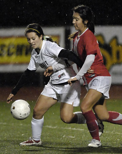 JSH_WHS_DSC9085b Alison Martin (left) of Jesuit beats Westview's Desiree Tyner (right) to the ball in midfield during second half action.