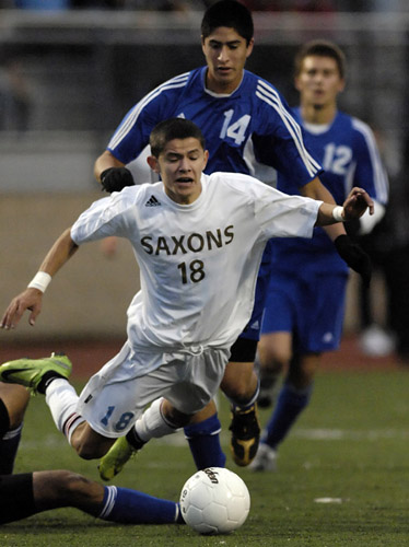 SSHS_SMHS_DSC7649b Jose Reyes (18) of South Salem goes down to the turf after being tripped up by South Medford's Josue Rodriguez (off camera left).