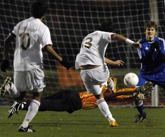 SSHS_SMHS_DSC7849b After recovering from a collision with South Salem's Pablo Ceja (13), South Medford goalkeeper Mitch North dives in a despirate attempt to block Ceja's shot onto an open net. North could not get a hand on the ball but was saved by teammate Cody Anders who miraculously headed the ball wide of the post at the last second.