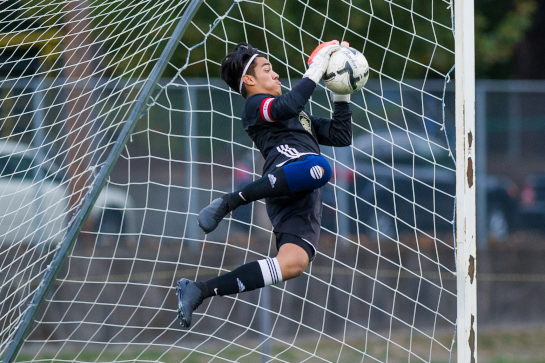 Milwaukie OSAA 5A first team all-state goalkeeper Juan De Dios Inzunza makes a diving save off a first half Putnam free kick.