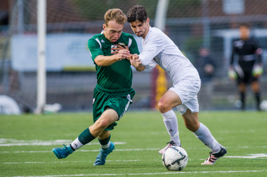 Devin Duval (7) of Milwaukie battles for a loose ball against Rex Putnam midfielder Garrett Benedict (3).