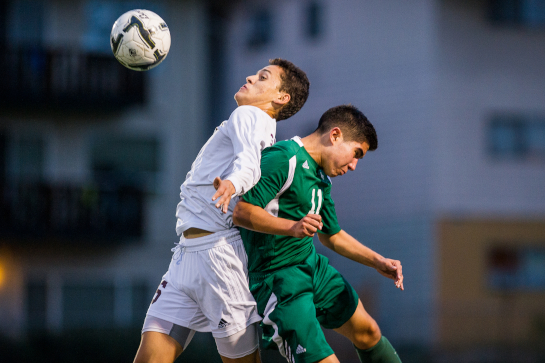 Juan Gudino (6) of Milwaukie wins an aerial challenge against Rex Putnam midfielder Emilio Rodgers (11).