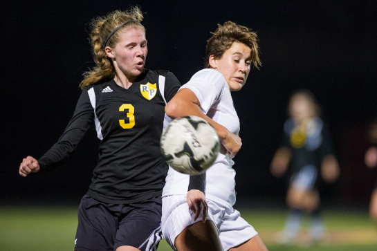 Rex Putnam midfielder Kate Potter (3) and Milwaukie forward MaKenna Presley (right) challenge for a loose ball during the second half.