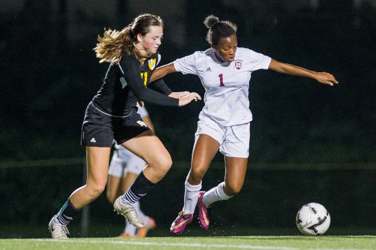 Milwaukie midfielder Noelani McGowan (1) dribbles the ball under pressure from Rex Putnam midfielder Megan Spaulding (11).